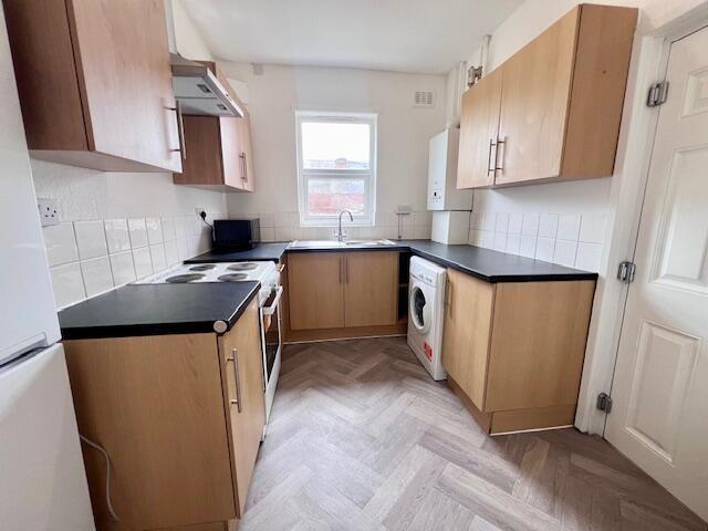 Bright and modern kitchen featuring ample count...