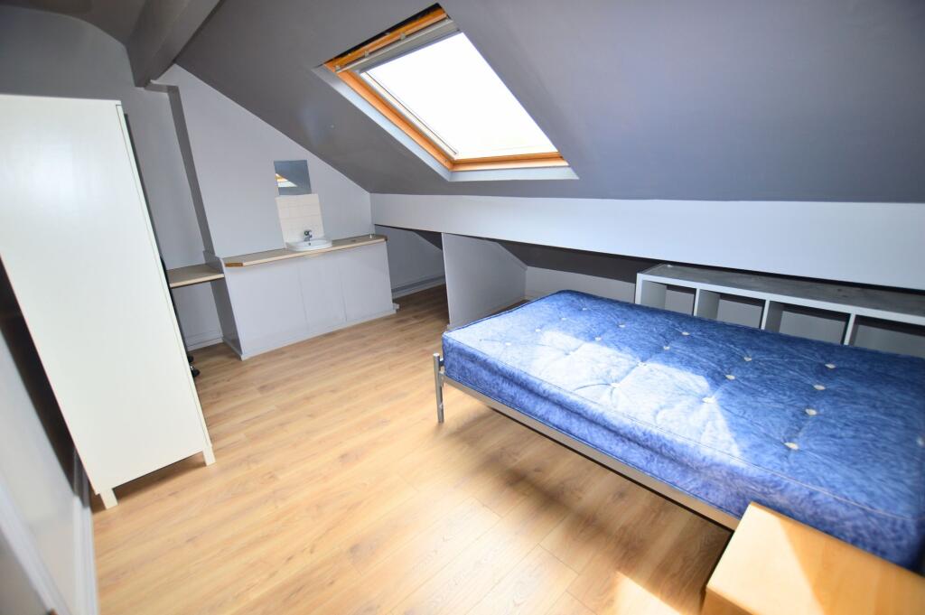 Bright single bedroom with a large skylight pro...