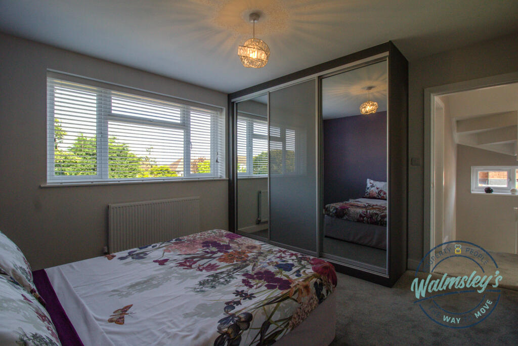 Bedroom three with hallway beyond