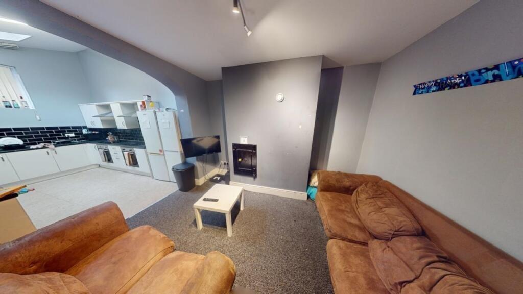 A comfortable living room featuring cozy brown ...