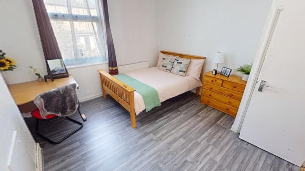 A bright and inviting double bedroom featuring ...