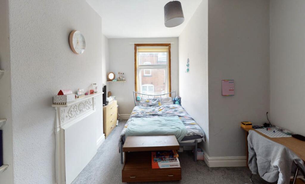 A cozy bedroom with a double bed, featuring nat...