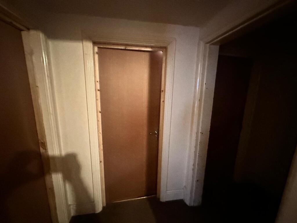 A well-defined hallway featuring clean walls an...