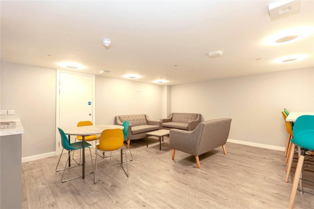 A modern communal lounge featuring comfortable ...