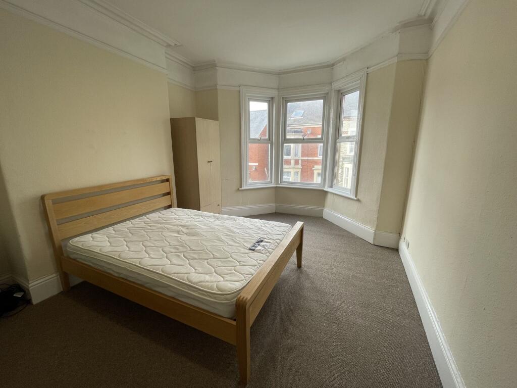 Bright and spacious master bedroom with a large...
