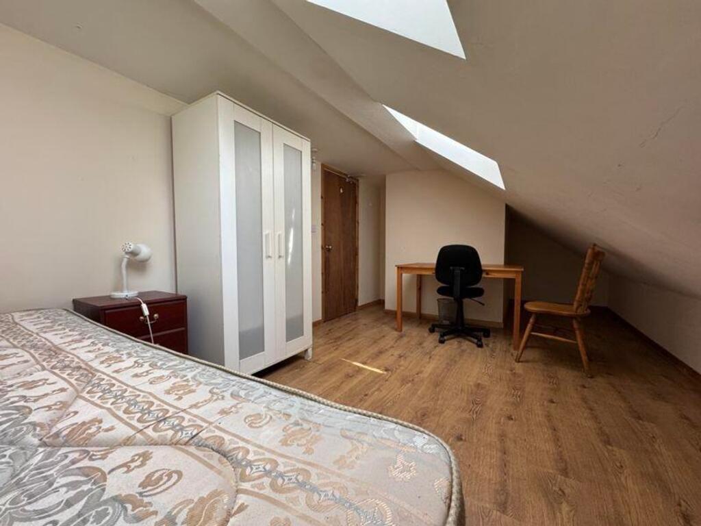 A bright and inviting double bedroom featuring ...