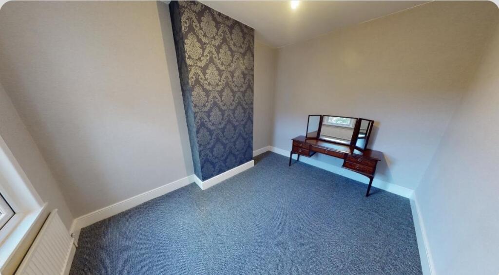A neat and well-maintained bedroom featuring so...