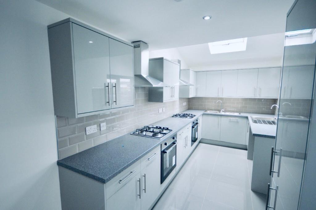 A modern and spacious kitchen equipped with sle...