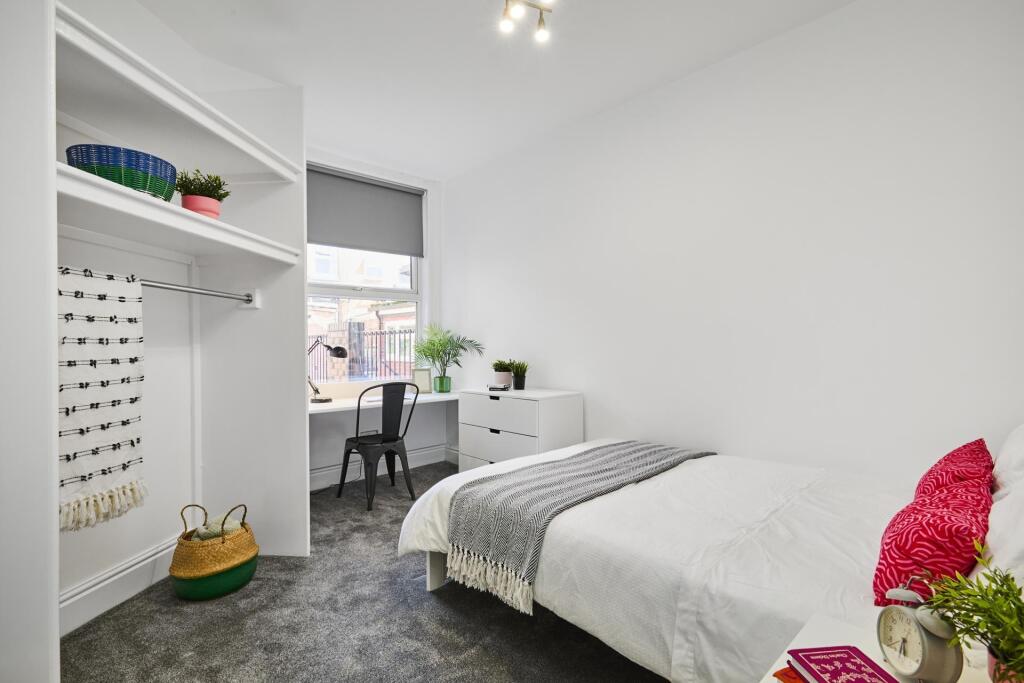 Bright, uncluttered bedroom with a comfortable ...