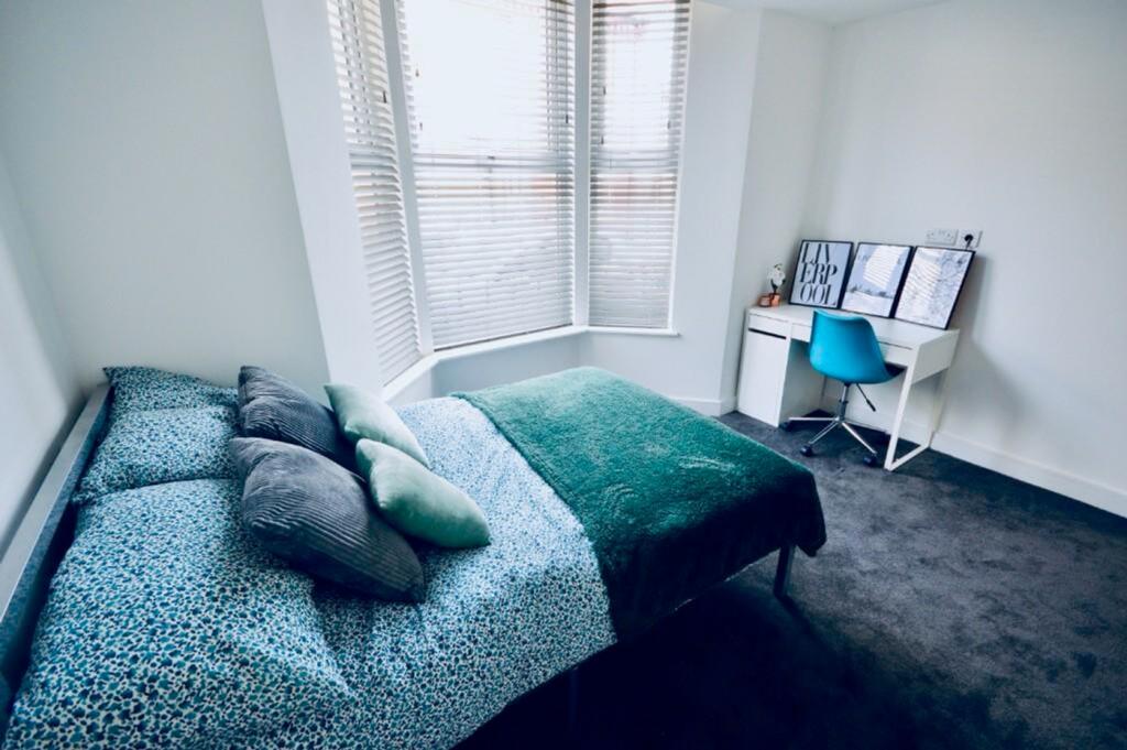A bright and inviting double bedroom featuring ...