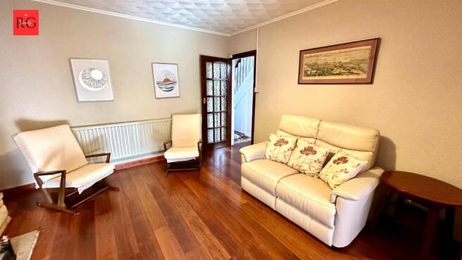 A warm and inviting living room featuring polis...