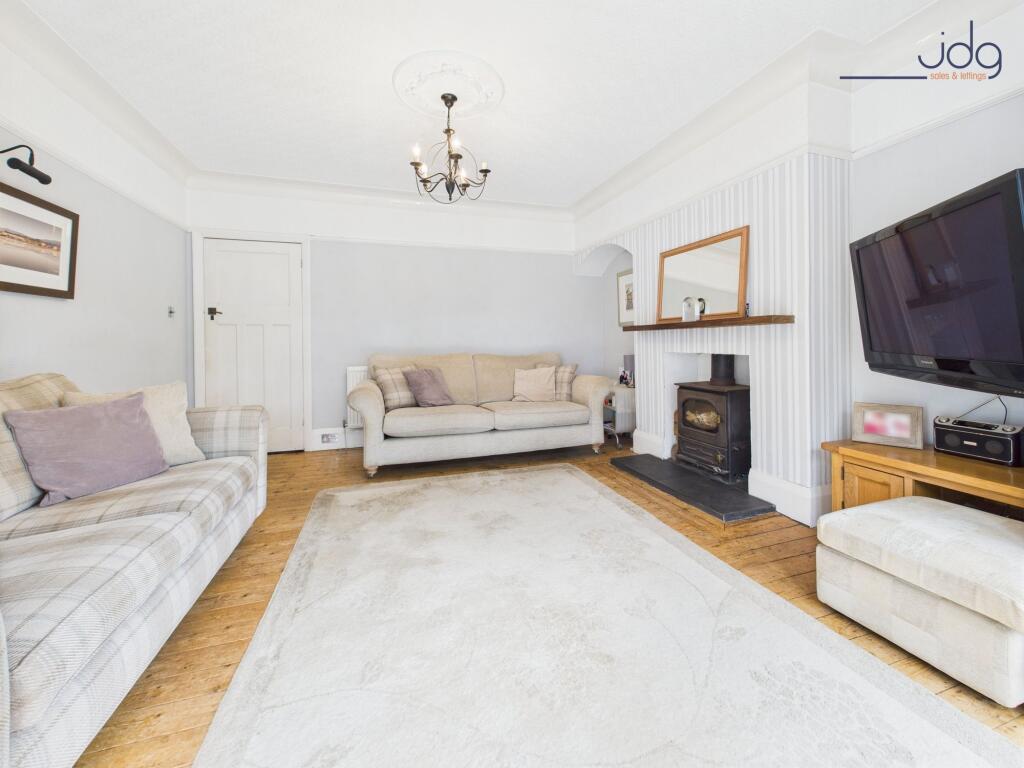 Cosy Lounge with River Views and Log Burner