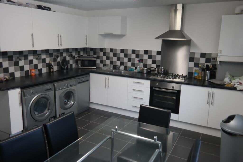 A modern and spacious kitchen equipped with ess...