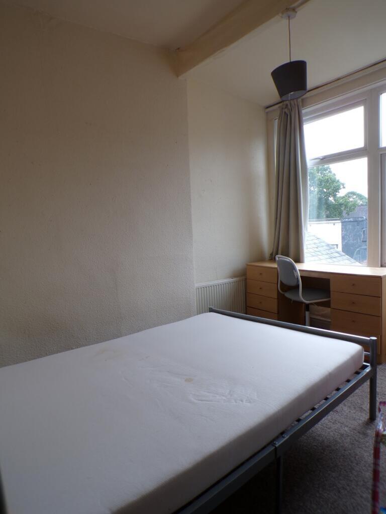 A bright and spacious double bedroom featuring ...