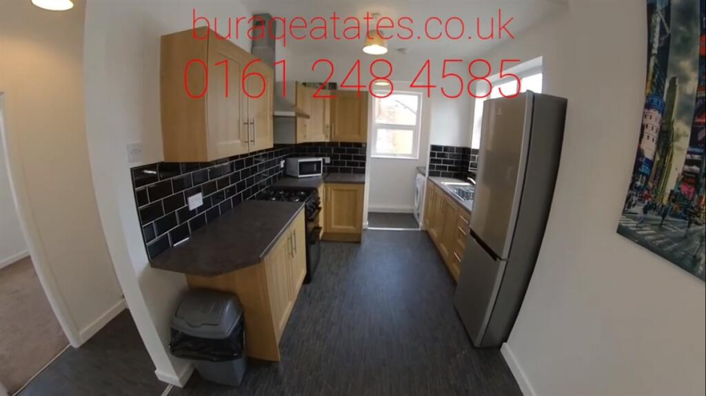 Bright galley-style kitchen with modern fitted ...