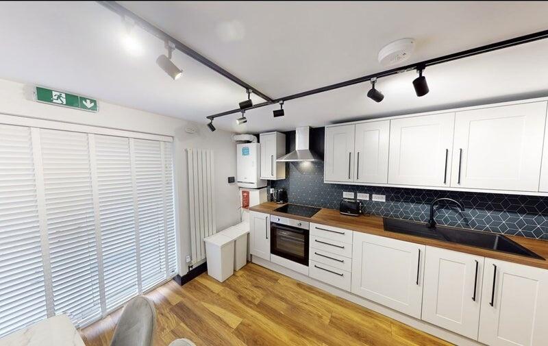 Bright modern kitchen with white shaker cabinet...