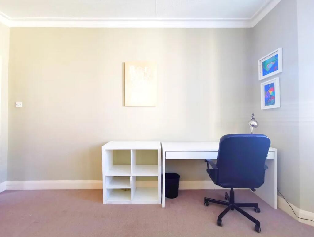 A bright and tidy communal workspace featuring ...
