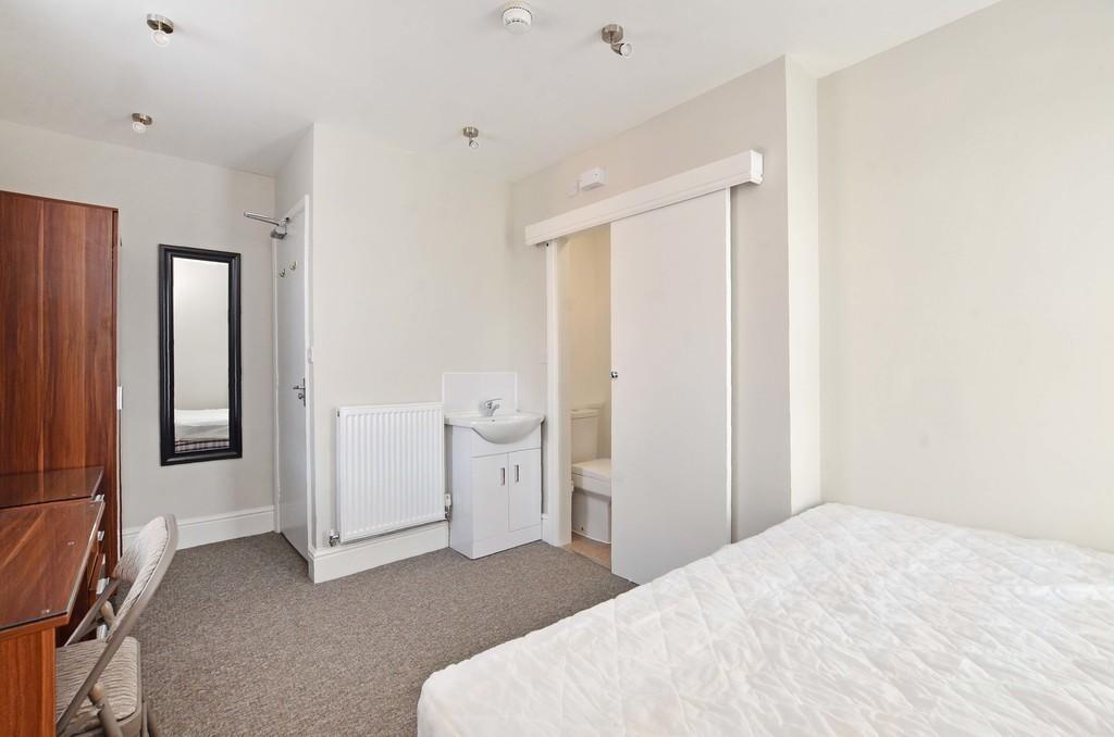 Bright and tidy single bedroom featuring a cozy...