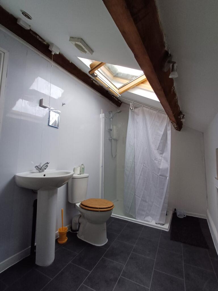 Well-maintained bathroom featuring a sink, toil...