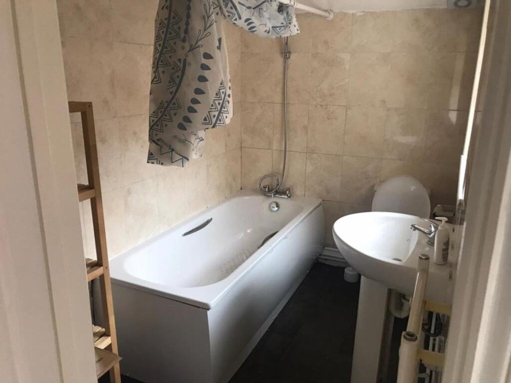 A clean and functional bathroom featuring a bat...