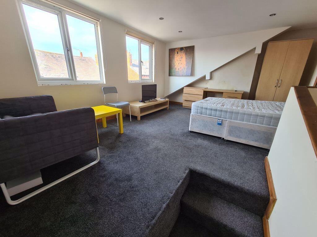 Spacious and well-lit master bedroom featuring ...