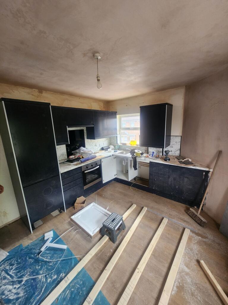 A kitchen space featuring modern black cabinetr...