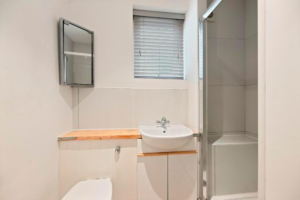 A clean and functional bathroom featuring a com...