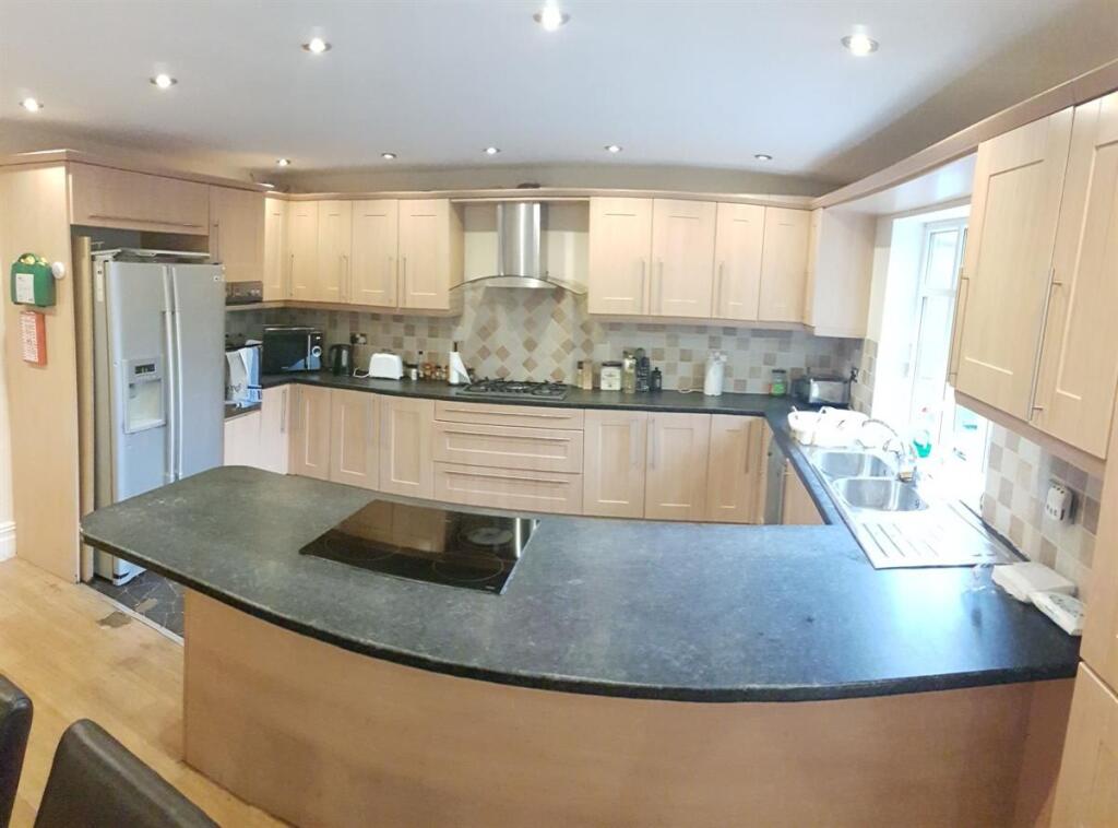 Bright modern kitchen with a large curved break...