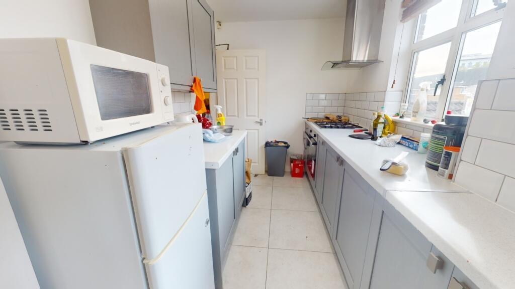 Bright and tidy kitchen featuring ample counter...