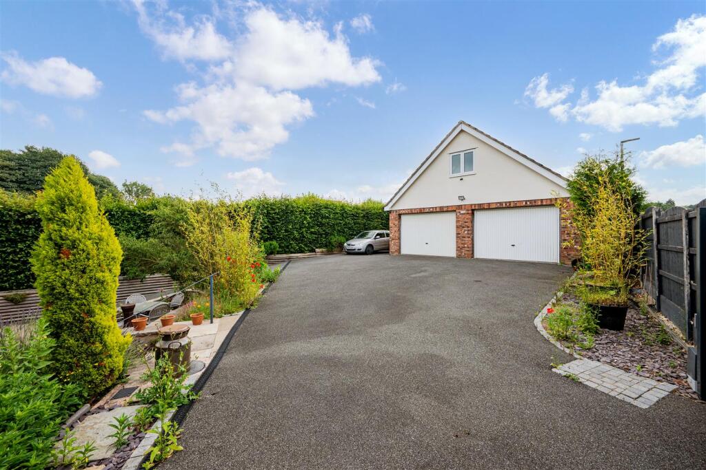 Driveway leading to detached garage