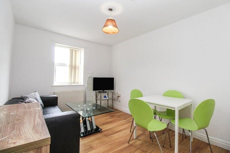A bright and tidy living room featuring a moder...