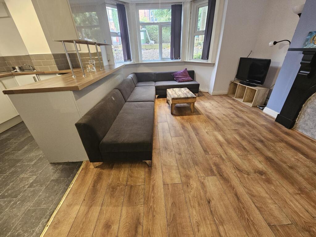 A spacious, well-lit contemporary living room f...