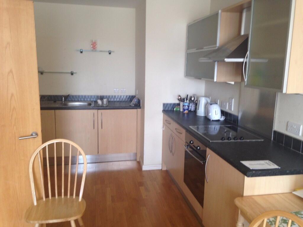 A compact and tidy kitchen featuring wooden cab...