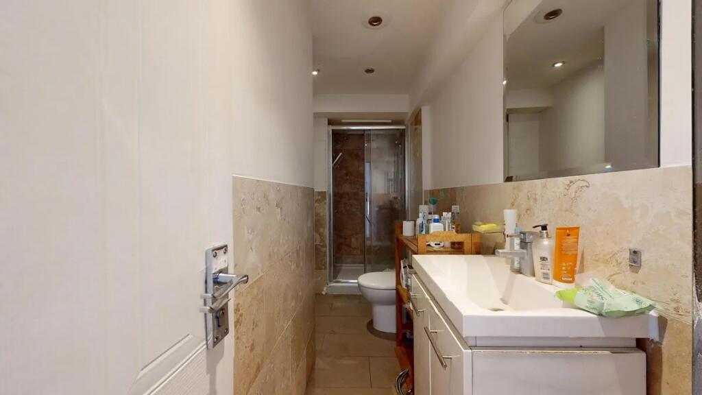 A modern bathroom featuring a clean white sink ...
