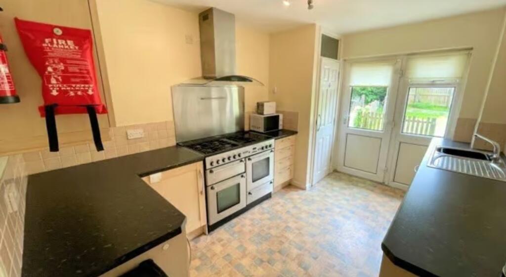Bright kitchen featuring a large double oven wi...