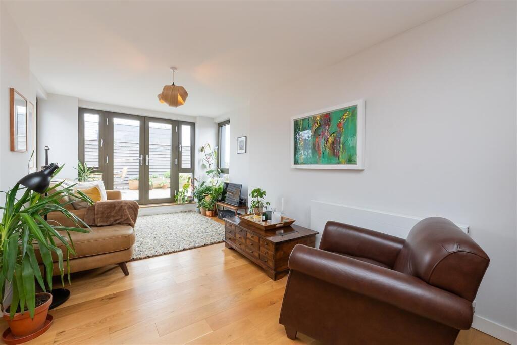 A bright and inviting living room featuring lar...