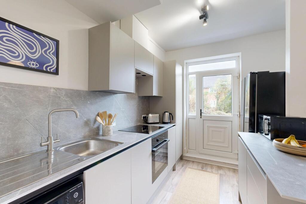 Bright and modern kitchen with ample natural li...