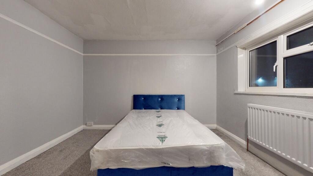 Bright and spacious double bedroom featuring a ...