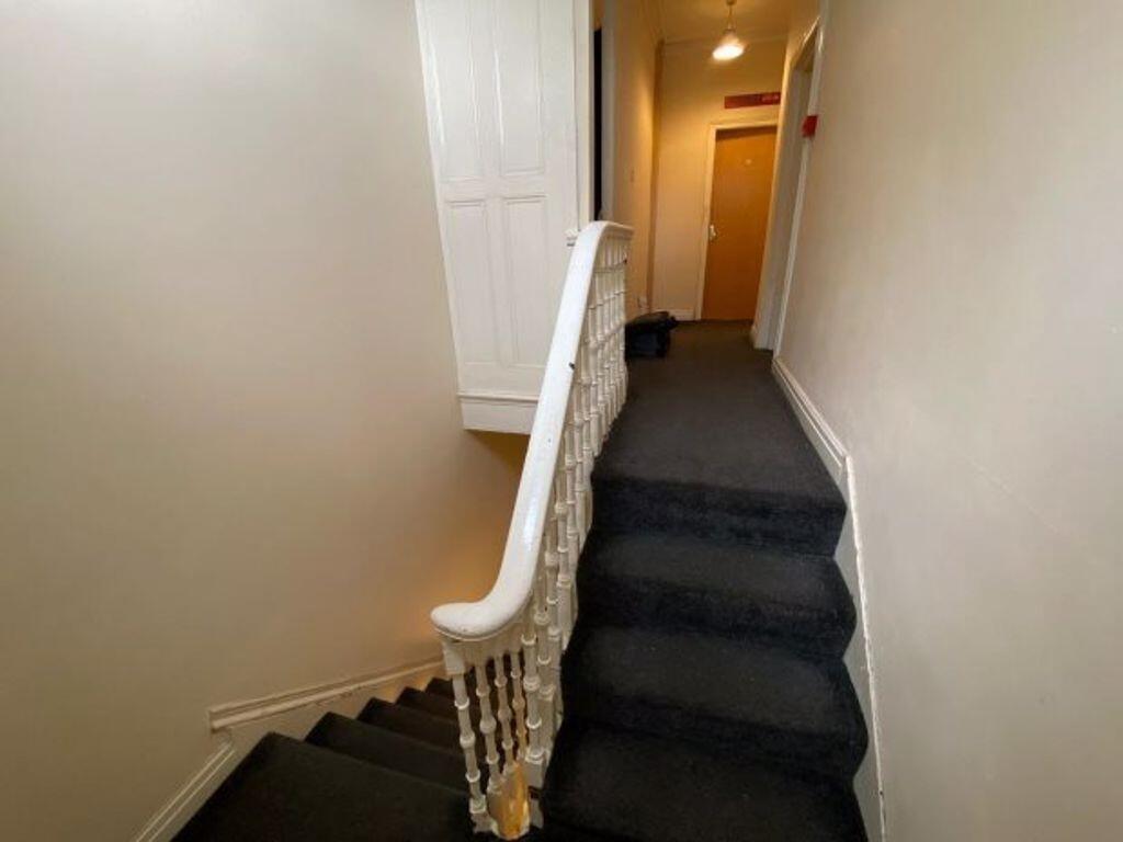 A clean and well-maintained hallway featuring a...
