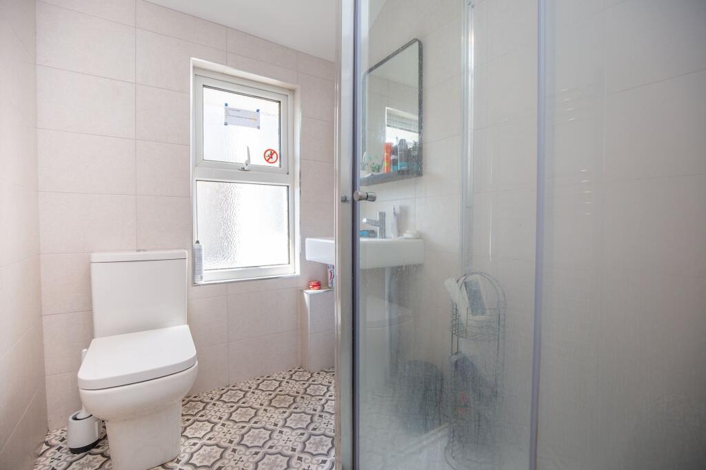 Bright and modern bathroom featuring a patterne...