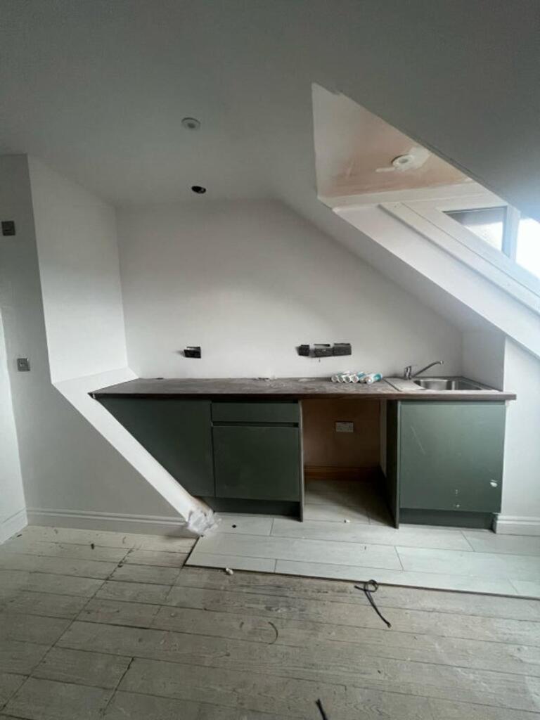 A modern kitchen space featuring sleek cabinetr...