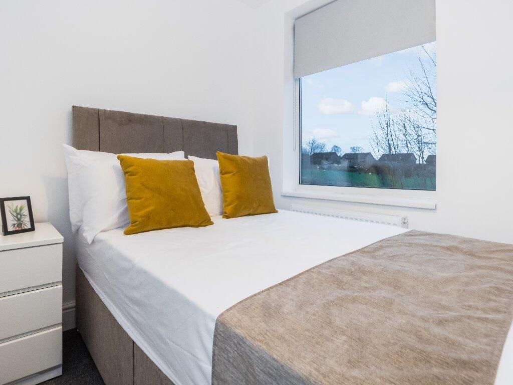 A bright and neatly arranged double bedroom fea...