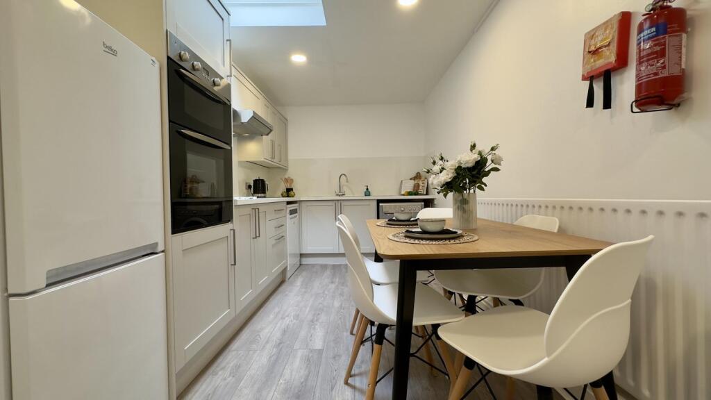 A bright and modern kitchen featuring a dining ...