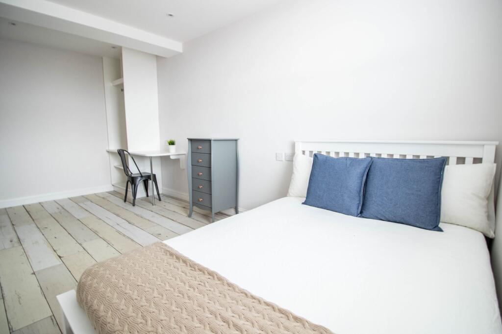 A bright and well-maintained bedroom with a sim...