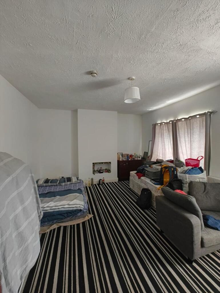 A spacious living room featuring a bold black a...