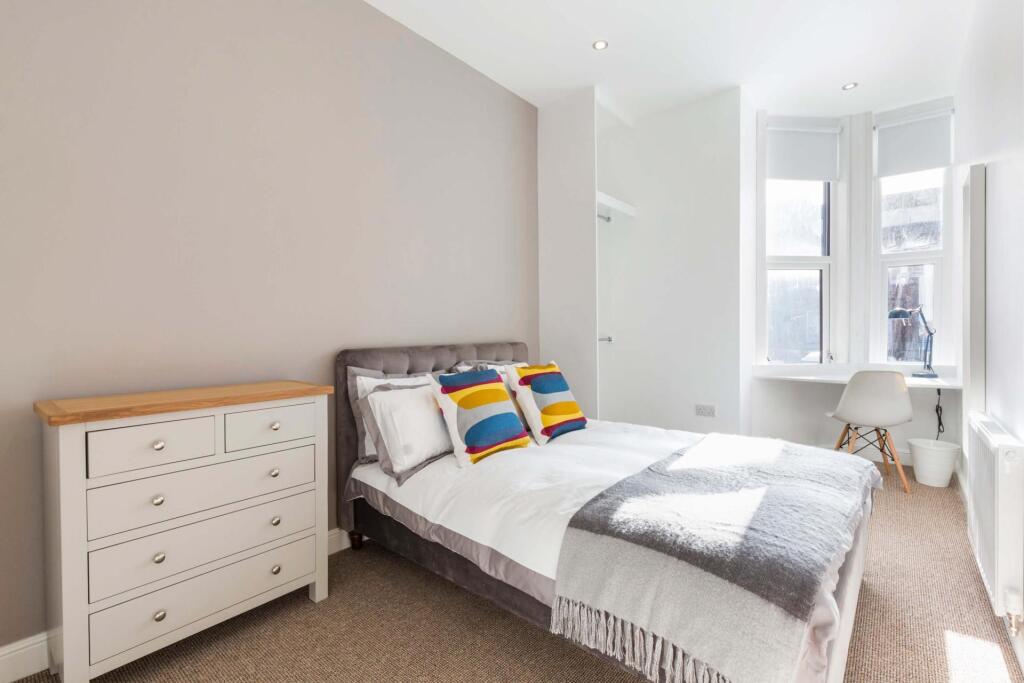 Bright, neatly presented bedroom with a double ...