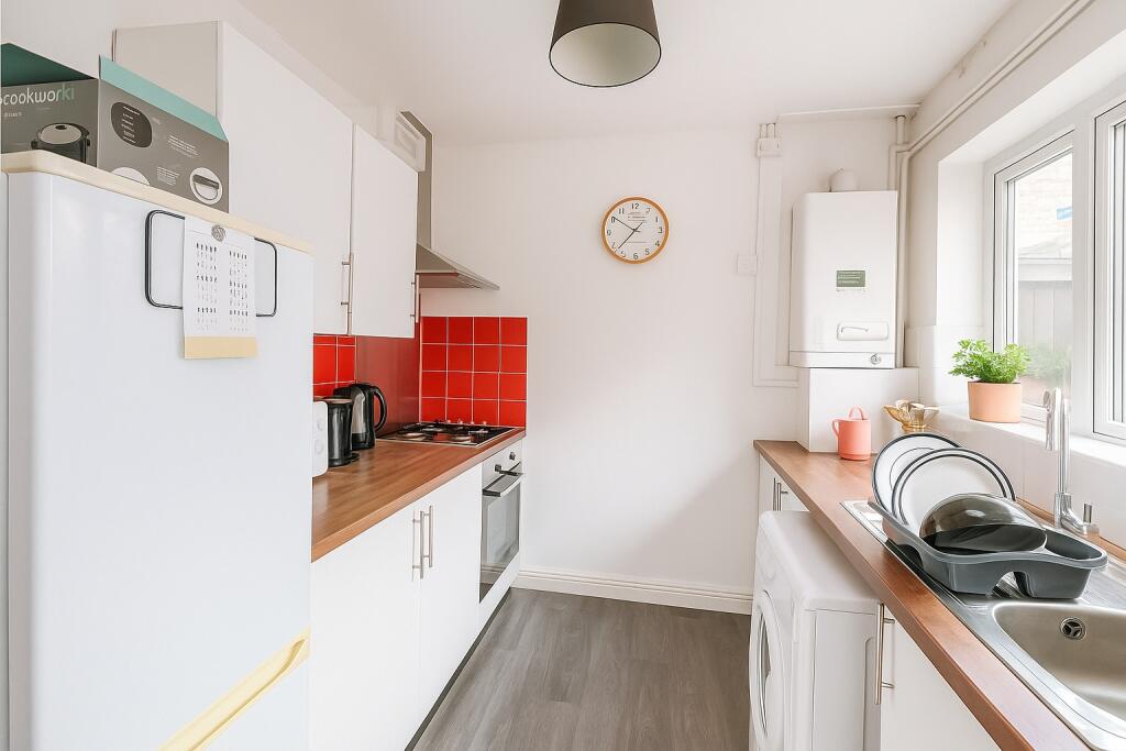 Bright and clean kitchen featuring modern white...