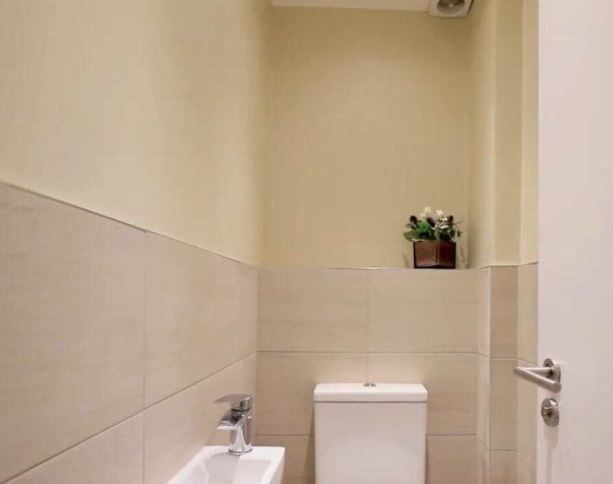 A clean and neatly maintained single toilet wit...