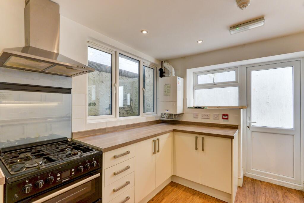 Bright and modern kitchen featuring ample count...