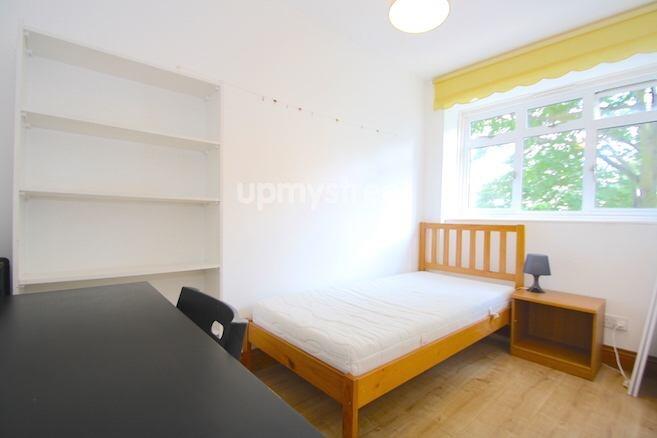 A bright and clean student bedroom featuring a ...